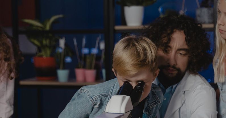 Learning - Student Looking at a Microscope