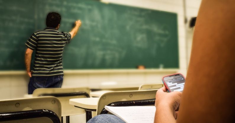 Teaching - Man in Black and White Polo Shirt Beside Writing Board